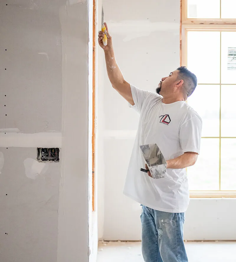 TL Services T&L Drywall & Construction worker texturing drywall
