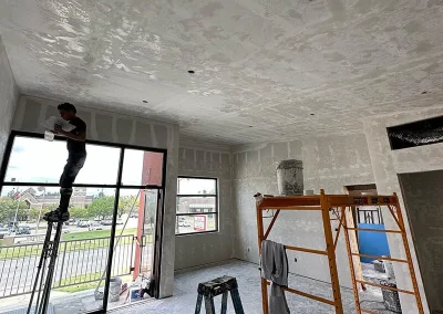 Worker patching drywall